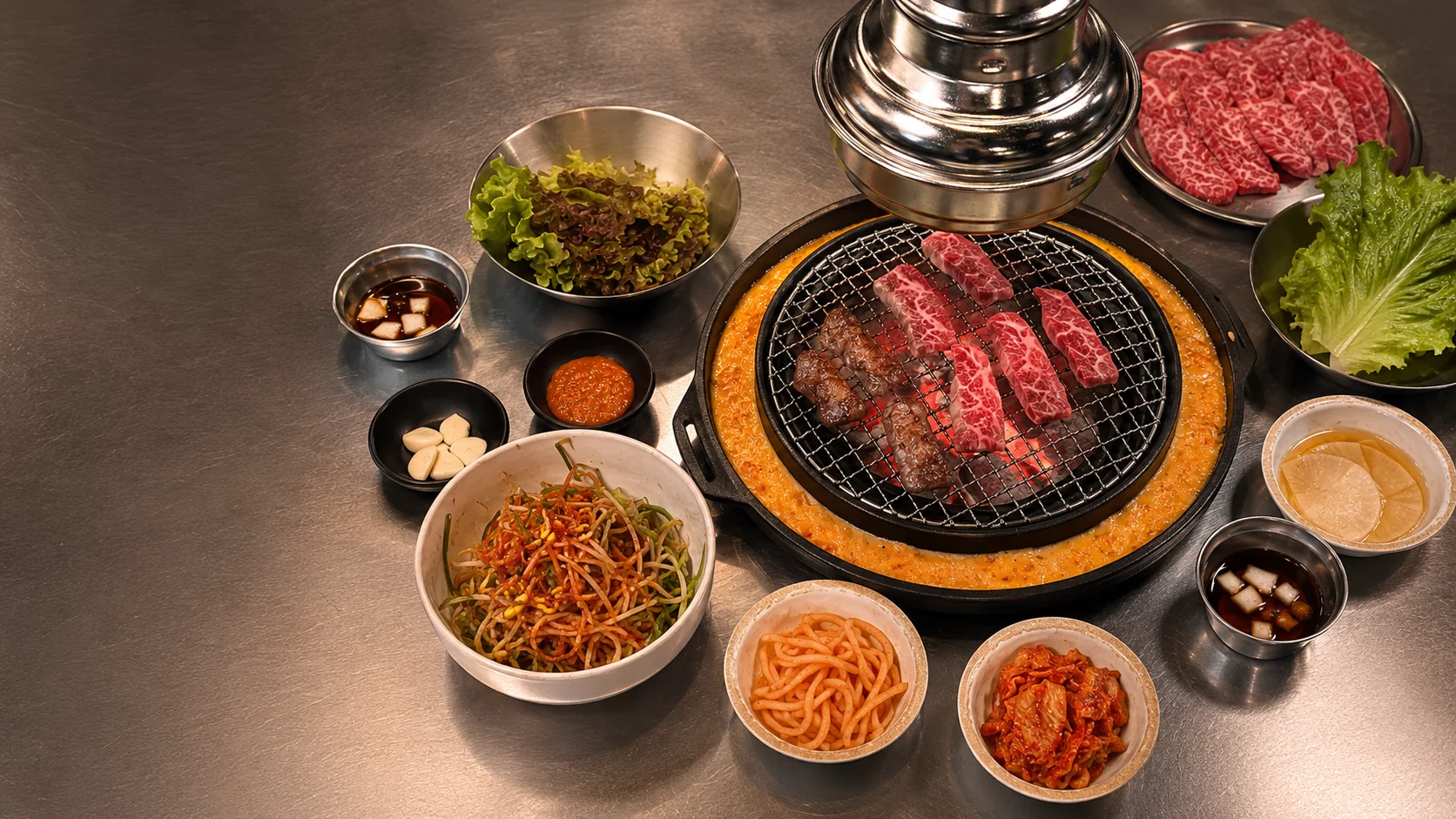 A Korean barbecue table spread with marbled beef, banchan, and dipping sauces